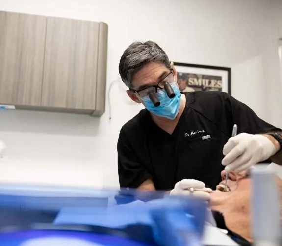 A Westchester Dental Group dentist treating a patient, wearing magnifying loupes.