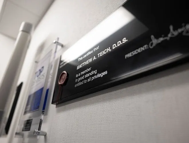 Dr. Matthew Teich's membership plaque on the office wall.